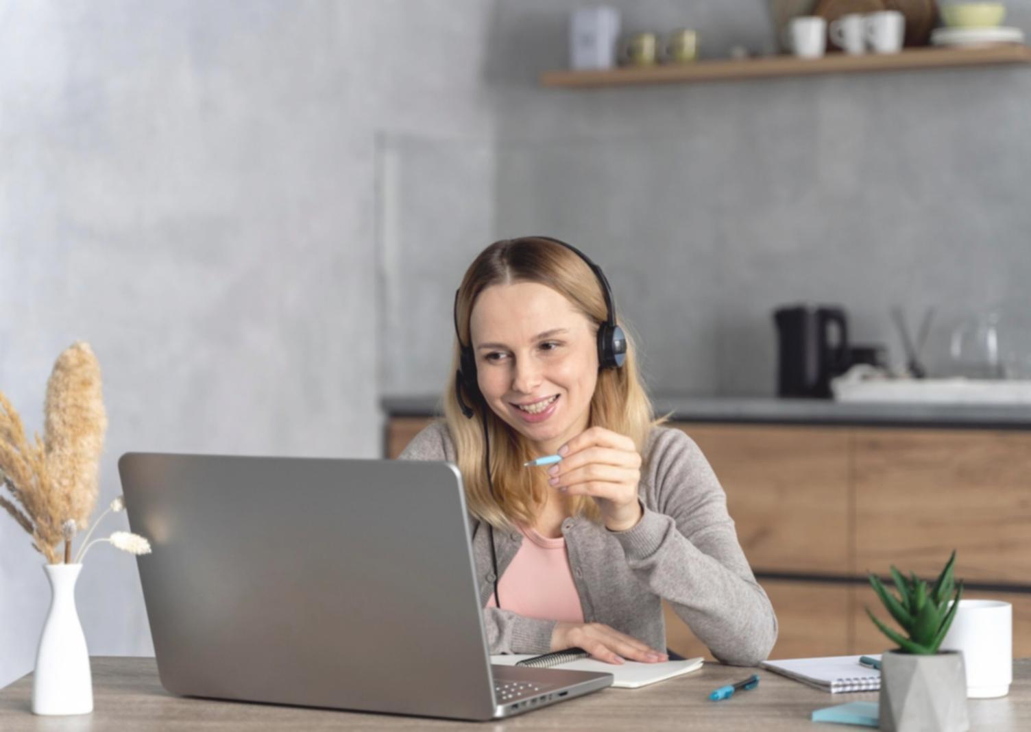Person using laptop for online financial planning with notebook and calculator